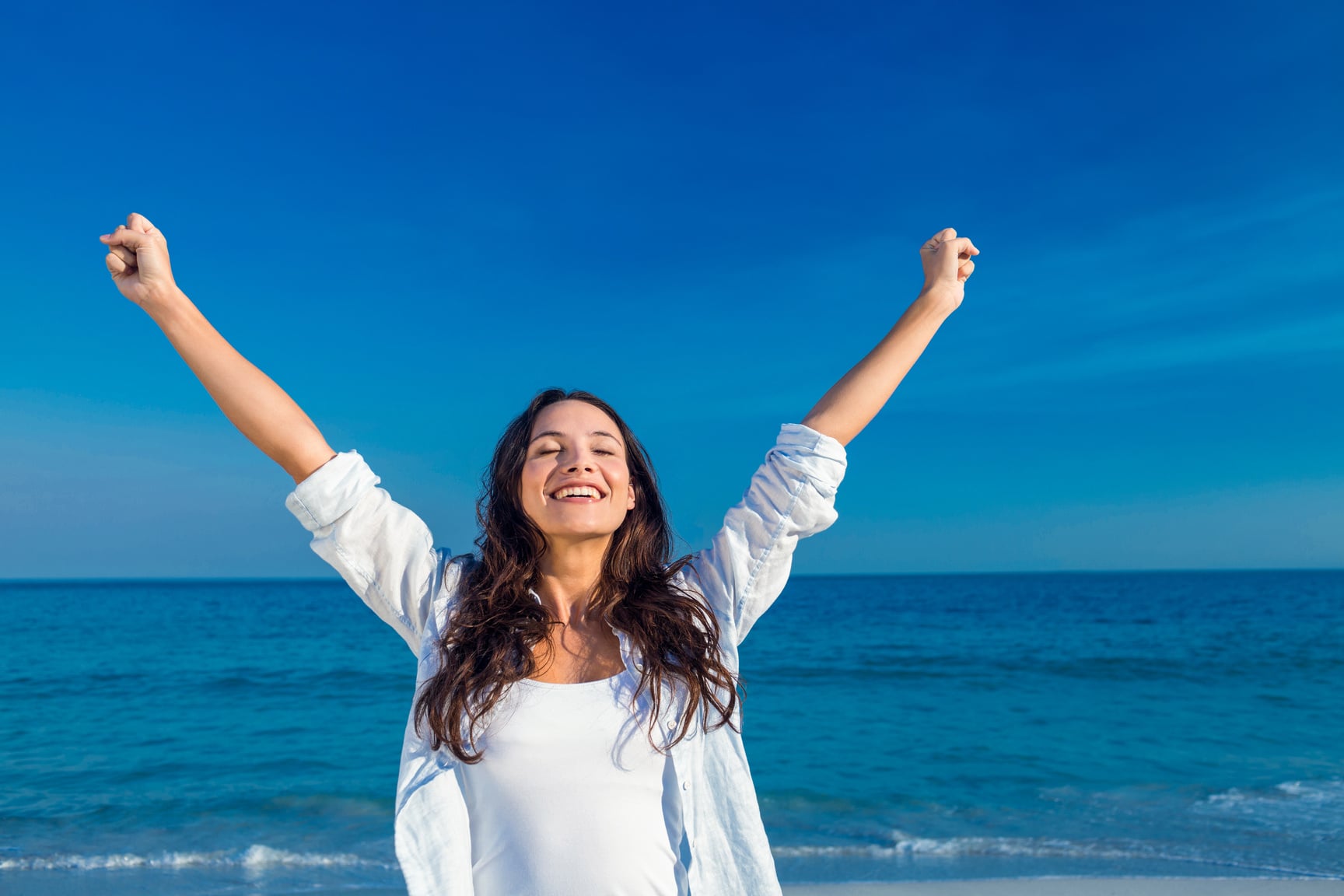 Happy woman smiling at the beach